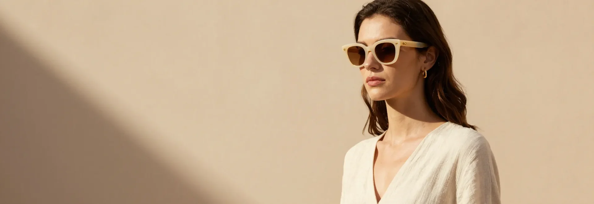 Cream and gold sunglasses in warm Mediterranean light